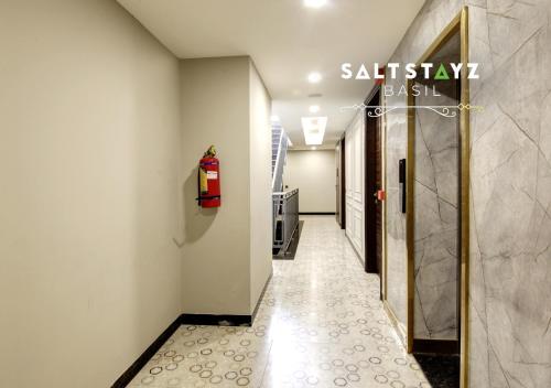 a hallway with a sign that reads sakurabushbush at Saltstayz Basil - Near Golf Course Road & Extension Road in Gurgaon
