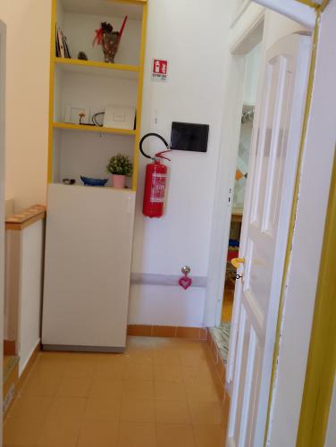 a hallway with a white door and a red fire extinguisher at A Casa Di Agata in Pellezzano