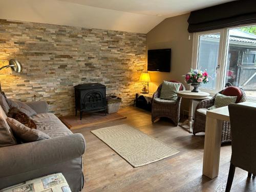 a living room with a brick wall and a fireplace at Veld en Bosch in Leusden