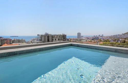 a swimming pool with a view of the city at Oceanfront Bliss with Breathtaking Views in Cape Town