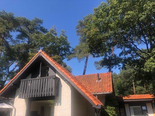a house with an orange tiled roof at Studio Enschede Twente - Rust, natuur & gratis parkeren in Enschede