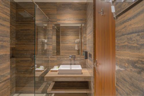 a bathroom with a sink and a glass shower at Baantalai Resort- Baba Balak Nath Shahtalai in Changar Talai