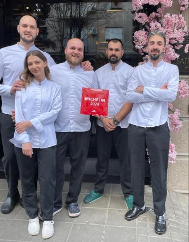 a group of men in white shirts posing for a picture at SAINT TEN Boutique Hotel, Small Luxury Hotels in Belgrade