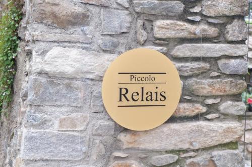 a sign on a stone wall with the words proctor relias at B&B Piccolo Relais in Lessolo