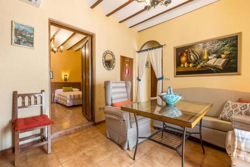 a living room with a table and a couch at Lavanda in Hinojares