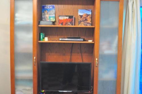a book shelf with a television in it at Nights of the Orient in Sharm El Sheikh