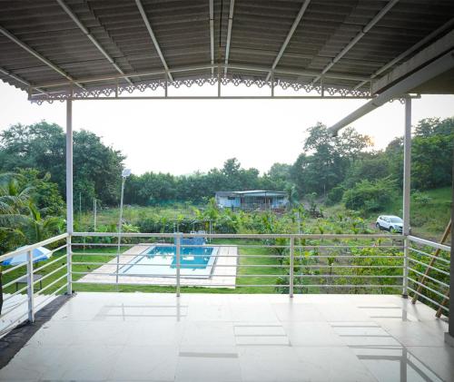 a view of a pool from the inside of a building at Malama Stay The Nest Villa 5BHK Kashid in Kashid