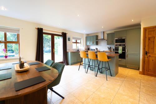 a kitchen and living room with a table and chairs at Townview Haven - Dingle in Dingle