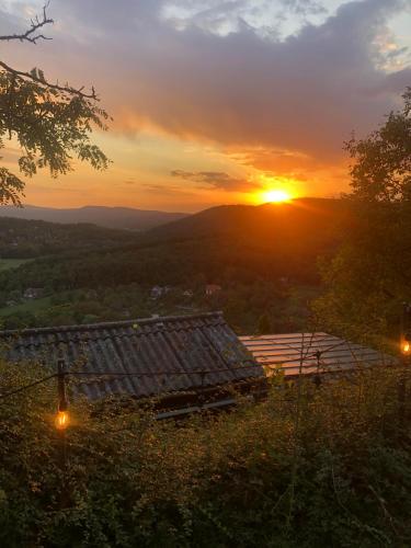 a view of the sunset from the roof of a house at Felhőfészek vendégház in Verőce
