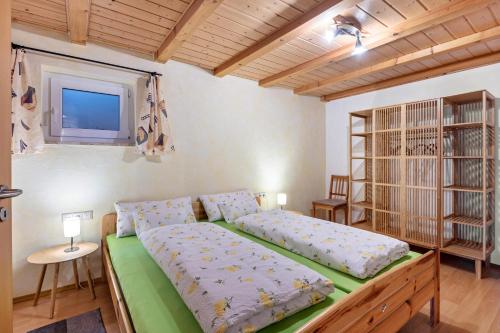 a bedroom with a bed and a tv on the wall at Ferienwohnung Schwalbennest in Höchenschwand