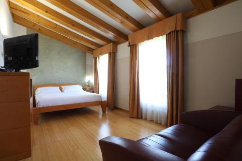 Postel nebo postele na pokoji v ubytování Hotel Della Torre 1850