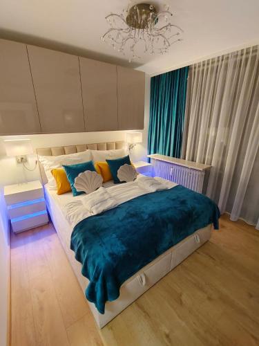 a bedroom with a large bed with a blue blanket at Appartement AquaQuelle in Bad Füssing