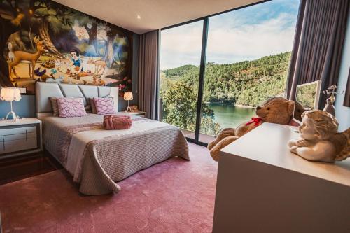 a bedroom with a bed and a large window at Quinta da Mimosa in Vieira do Minho