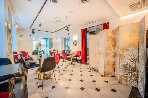 a dining room with red chairs and a table at ITC Infantas by Soho Boutique in Madrid