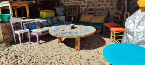 a room with a table and chairs and a couch at Maison de caractère in Viverols