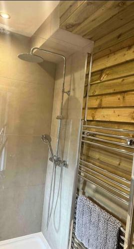 a shower in a bathroom with a glass door at Beautiful Cotswold Couples Retreat in Bourton on the Water