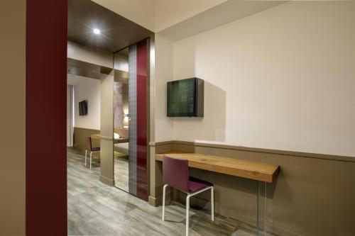 a room with a wooden table and a purple chair at Hotel Regno in Rome