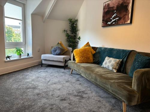 a living room with a couch and a chair at Island Heights By MGroupSA in Barry
