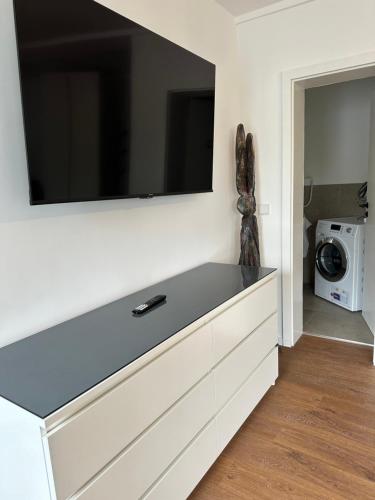 a living room with a large flat screen tv on a wall at Living 77 in Fulda