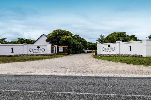 two white buildings with the word original on them at Hotel Olivewood in East London