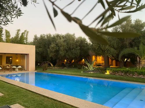 a swimming pool in the backyard of a house at Jardin Sakina - Chambre d'hôtes in Marrakech