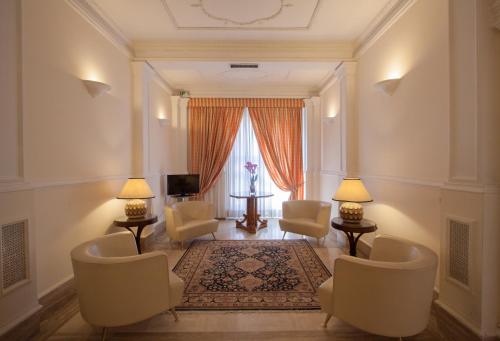 a living room with chairs and a table and a window at Hotel Laurentia in Rome