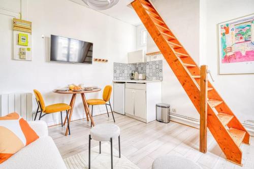 - un salon avec un escalier, une table et des chaises dans l'établissement Studio proche Mairie du 14e arrondissement - V, à Paris