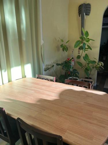 a large wooden table in a room with chairs at ちょこっとヴィラMaestro in Tusi
