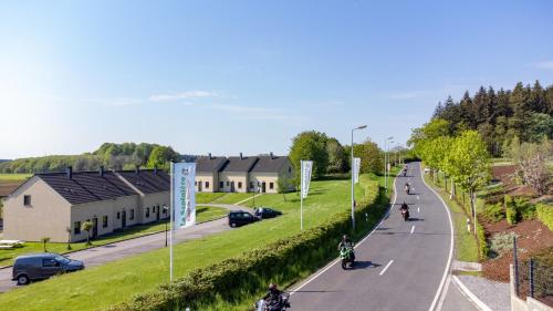 a group of people riding motorcycles down a road at Holiday Park La Sapinière in Hosingen