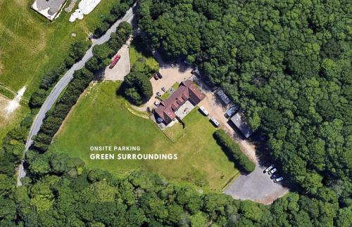 an aerial view of a house in the middle of a forest at Little Foxes Hotel & Gatwick Airport Parking in Crawley
