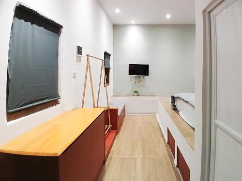 a classroom with a blackboard on the wall at Urbanview House of IKIGAI in Madiun