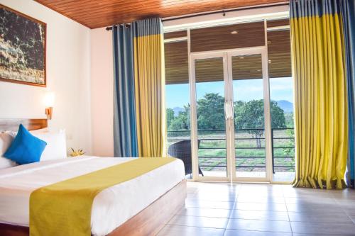 Postel nebo postele na pokoji v ubytování Hotel Sigiriyaaya