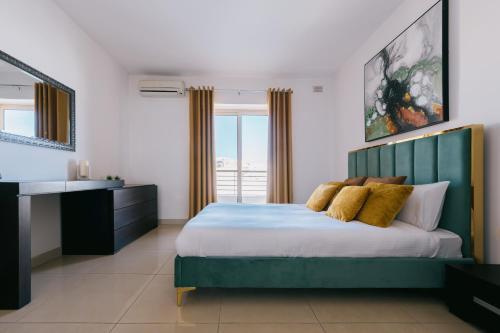 a bedroom with a large bed and a window at Sunny 2 BR Aptm with Garden Fast WiFi Walk to Seafront in Il-Gżira
