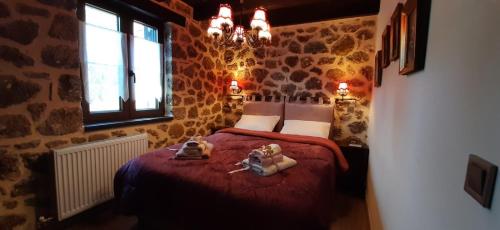 a bedroom with two stuffed animals sitting on a bed at Νόστος in Ano Trikala