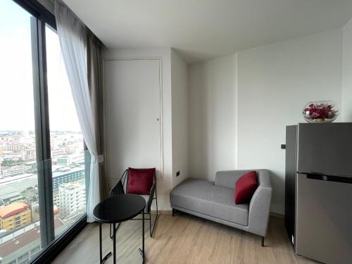 a small living room with a couch and a window at Edge Central Pattaya By Su in Pattaya Central