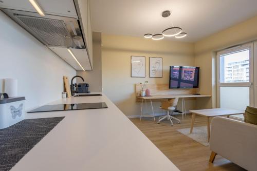 a kitchen with a sink and a desk at VIP Apartament Kopisto CENTRUM in Rzeszów
