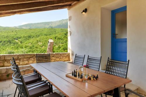 a dining room with a table and chairs and a large window at Villa Eugenia for 8 people with private pool & large garden only 3 km from the beach in Mošćenička Draga