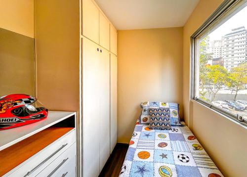 a small room with a bed and a window at Apto espacoso c WiFi prox a Marginal Pinheiros SP in Sao Paulo