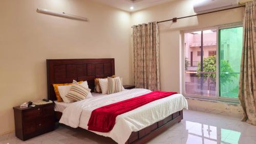 a bedroom with a large bed and a window at Haven Lodge, 3BR Entire Portion in Bahria Enclave Islamabad in Islamabad