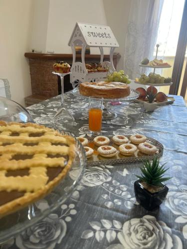a table with pies and other food on it at Incanto B&B in Reggio Calabria