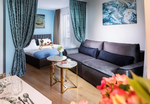 a living room with a couch and a bed at Free Parking On Premises Huge Terrace in Sofia