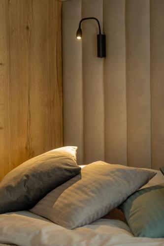 a bed with two pillows and a lamp on it at VIP Apartament Kopisto CENTRUM in Rzeszów