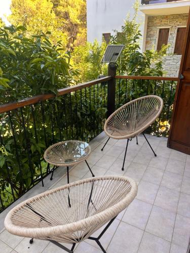 two chairs and a table on a balcony at Villa Christina in Vourvourou