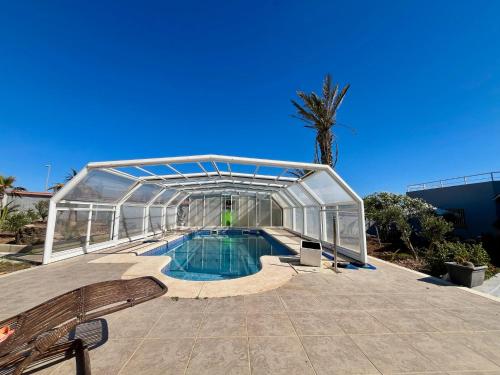 a glass house with a swimming pool in it at Castillo de Ralph in Guardias Viejas