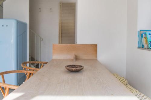 a wooden table with a bowl on top of it at Coastguard Lookout by Bloom Stays in Littlestone-on-Sea