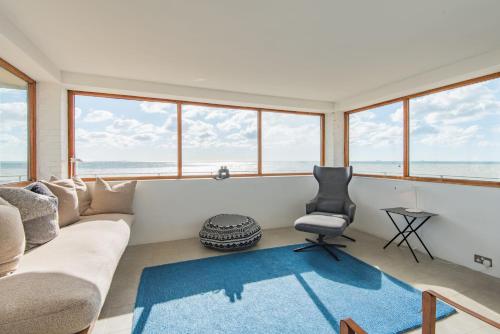 a living room with a couch and a chair at Coastguard Lookout by Bloom Stays in Littlestone-on-Sea