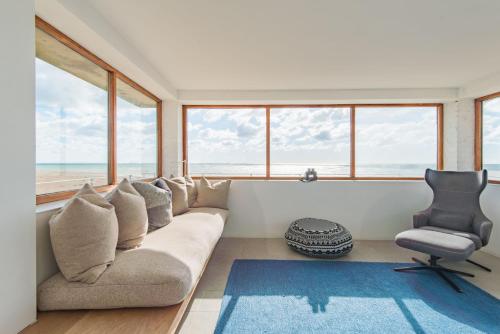 a living room with a couch and a chair at Coastguard Lookout by Bloom Stays in Littlestone-on-Sea