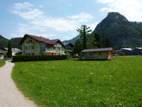 a house in the middle of a field of green grass at Haus Hedwig in Fuschl am See