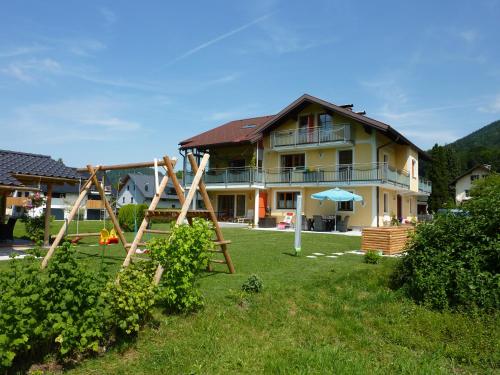a house with a playground in front of it at Haus Hedwig in Fuschl am See