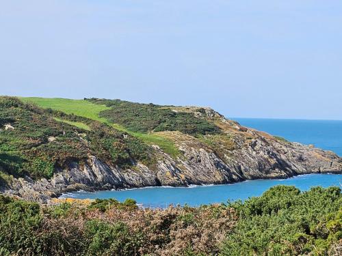 a view of an island with the ocean at Hedd in Amlwch